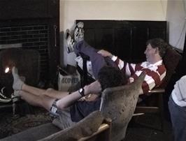 Michael puts his feet up by the fire after a long, wet day
